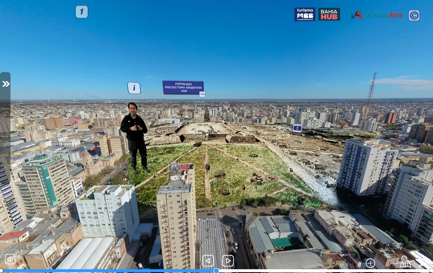 Vista panorámica aérea de Bahía Blanca con la reconstrucción de la Fortaleza Protectora Argentina de 1828 y el guía avatar en primer plano.